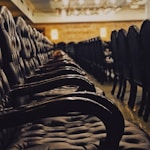 tufted black chairs inside building with no people