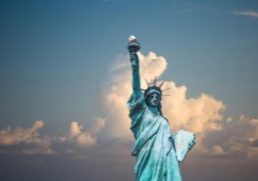 Iconic Statue of Liberty with majestic clouds in New York, USA. Perfect travel destination image.