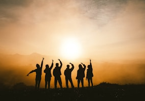 silhouette photo of six persons on top of mountain